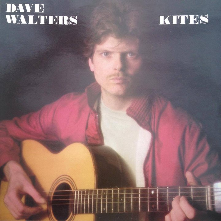 Sleeve of the album Kites: Dave Walters, young, with a moustache and a red jacket, holding an acoustic guitar